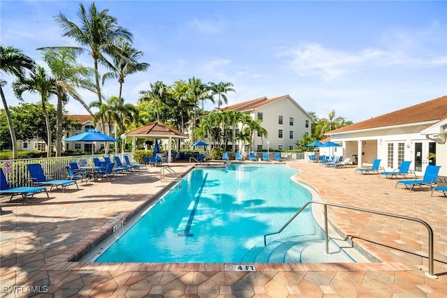 4665 Saint Croix Ln Unit 1525, Naples, FL 34109 - community pool with fence, a gazebo, french doors, and a patio area