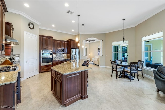 9337 Campanile Cir, Naples, FL 34114 - kitchen featuring extractor fan, visible vents, open floor plan, and appliances with stainless steel finishes