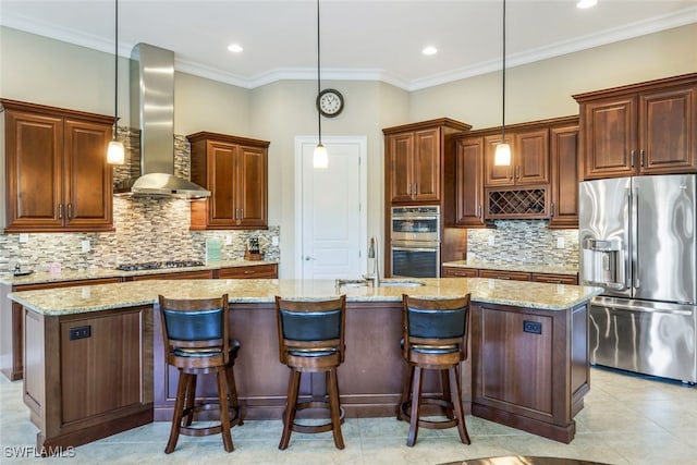 9337 Campanile Cir, Naples, FL 34114 - kitchen with a sink, wall chimney exhaust hood, appliances with stainless steel finishes, a kitchen island with sink, and ornamental molding