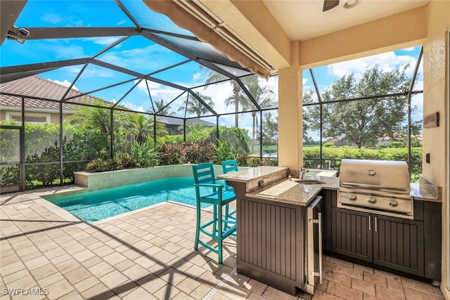 9337 Campanile Cir, Naples, FL 34114 - outdoor pool featuring outdoor dry bar, a grill, glass enclosure, area for grilling, and a patio area