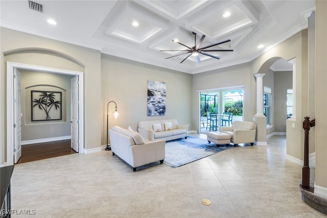 9337 Campanile Cir, Naples, FL 34114 - tiled living room with baseboards, visible vents, arched walkways, ornamental molding, and ornate columns