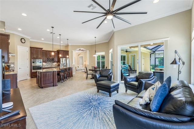9337 Campanile Cir, Naples, FL 34114 - living area featuring plenty of natural light, crown molding, recessed lighting, and a ceiling fan