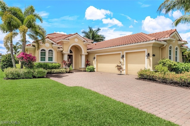 9337 Campanile Cir, Naples, FL 34114 - mediterranean / spanish-style house featuring decorative driveway, a tiled roof, stucco siding, and a garage