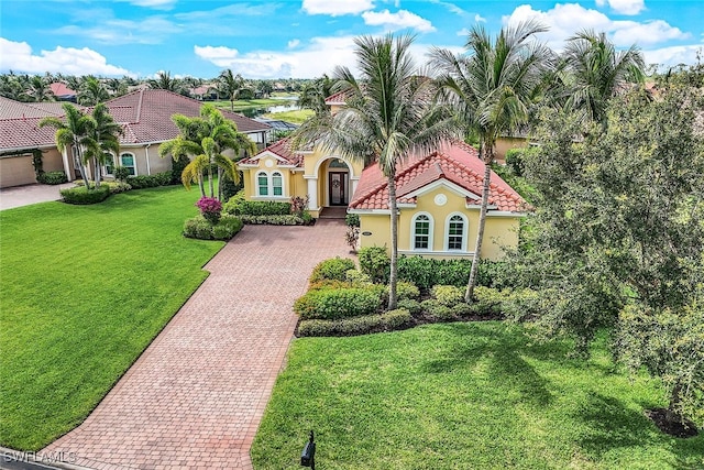 9337 Campanile Cir, Naples, FL 34114 - mediterranean / spanish-style home with a tile roof, decorative driveway, stucco siding, and a front lawn