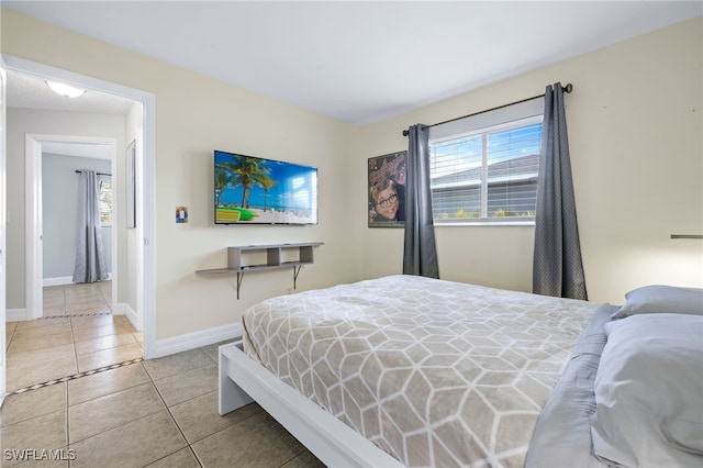 1015 SE 25th Ln, Cape Coral, FL 33904 - tiled bedroom with baseboards and multiple windows