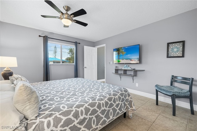1015 SE 25th Ln, Cape Coral, FL 33904 - bedroom with tile patterned floors, baseboards, ceiling fan, and a textured ceiling
