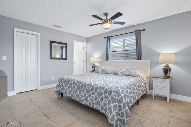 1015 SE 25th Ln, Cape Coral, FL 33904 - bedroom featuring tile patterned floors, a closet, a textured ceiling, baseboards, and visible vents