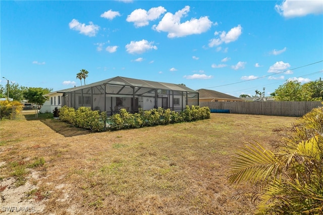 1015 SE 25th Ln, Cape Coral, FL 33904 - view of yard featuring a fenced backyard and glass enclosure