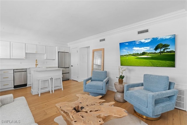 980 7th Ave S Unit 107, Naples, FL 34102 - living area with crown molding and light wood-style floors