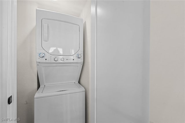 980 7th Ave S Unit 107, Naples, FL 34102 - laundry area featuring estacked washer and dryer and a textured wall