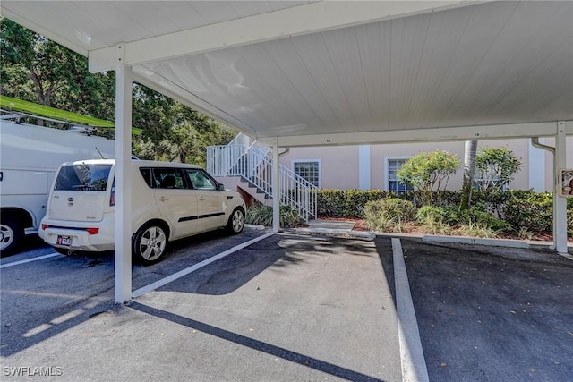 covered parking lot featuring stairs