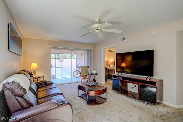 living room featuring visible vents, carpet flooring, baseboards, and ceiling fan