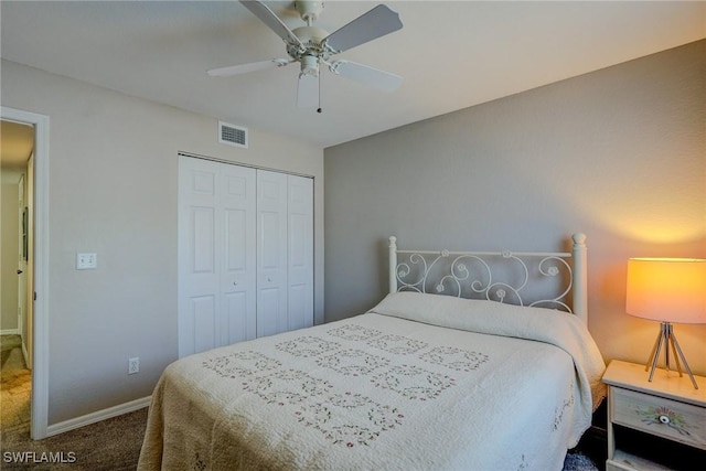carpeted bedroom with baseboards, visible vents, a closet, and ceiling fan