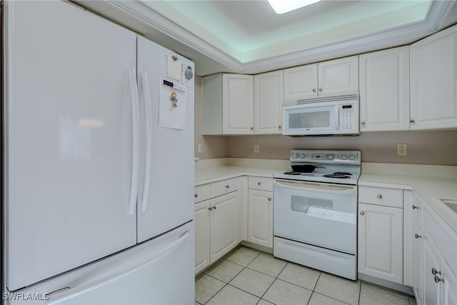 kitchen with light tile patterned flooring, light countertops, white cabinets, and white appliances