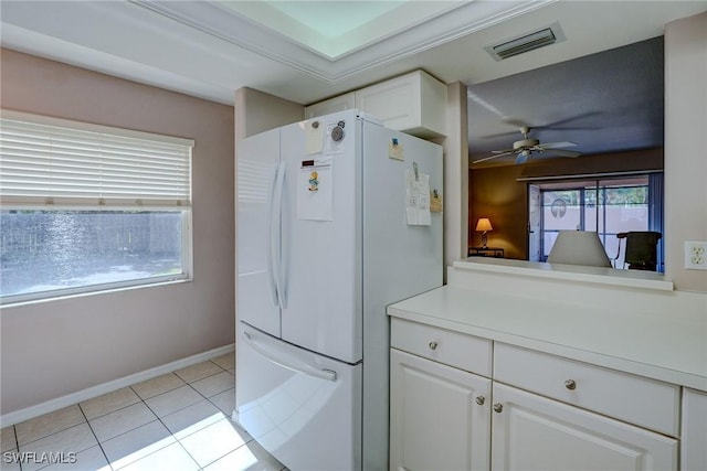 kitchen with visible vents, freestanding refrigerator, white cabinetry, ceiling fan, and light tile patterned floors