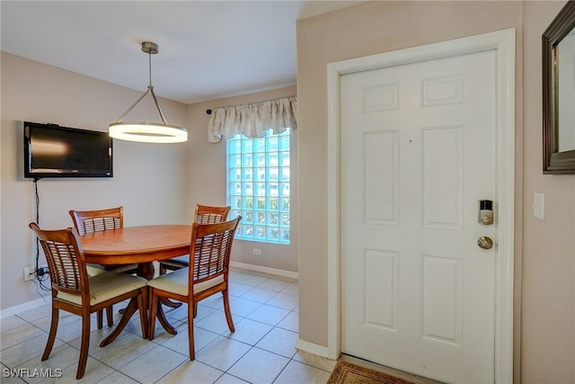 dining room with light tile patterned flooring and baseboards