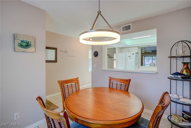 tiled dining space with ceiling fan, baseboards, and visible vents