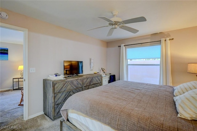 bedroom featuring ceiling fan, baseboards, and light colored carpet