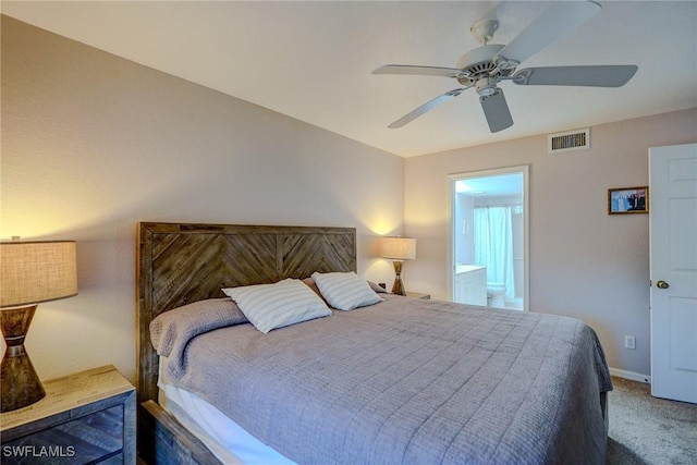 carpeted bedroom featuring baseboards, a ceiling fan, ensuite bathroom, and visible vents