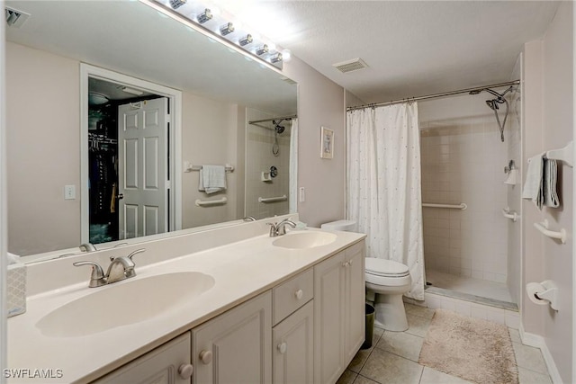 bathroom with a shower stall, visible vents, and a sink