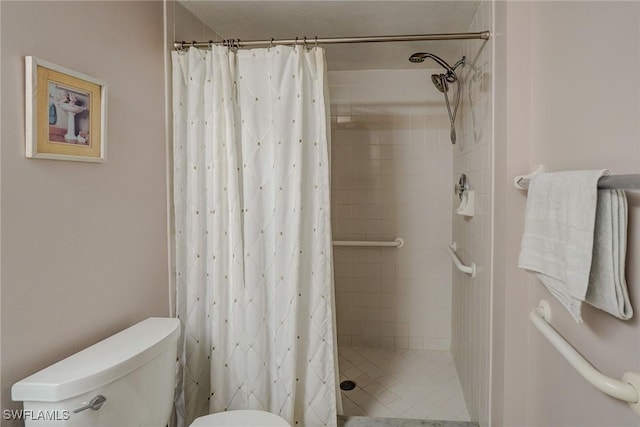 full bath with toilet and a stall shower