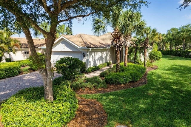 9512 Hemingway Ln, Fort Myers, FL 33913 - view of front of home with a garage, stucco siding, a front lawn, and a tile roof