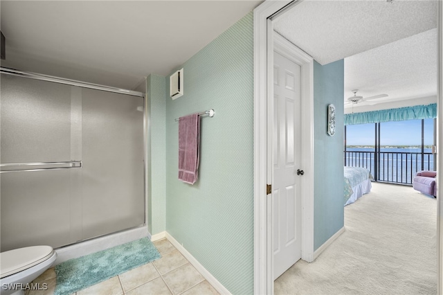full bathroom featuring baseboards, tile patterned flooring, a ceiling fan, toilet, and a shower stall