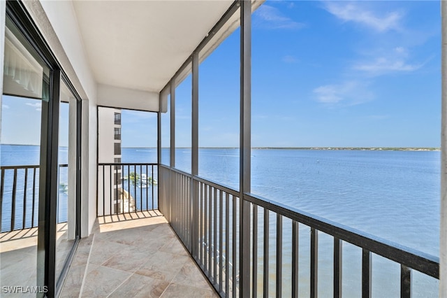 unfurnished sunroom featuring a water view