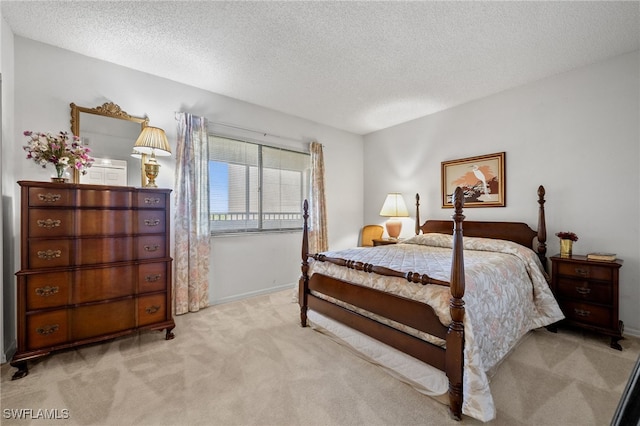bedroom with a textured ceiling, light colored carpet, and baseboards