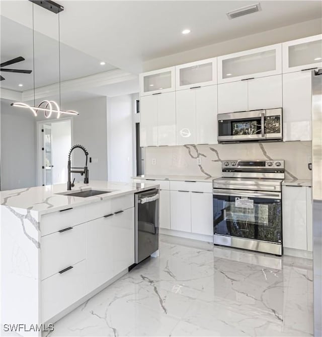 157 Everglades Blvd S, Naples, FL 34117 - kitchen featuring stainless steel appliances, modern cabinets, recessed lighting, a kitchen island with sink, and white cabinets