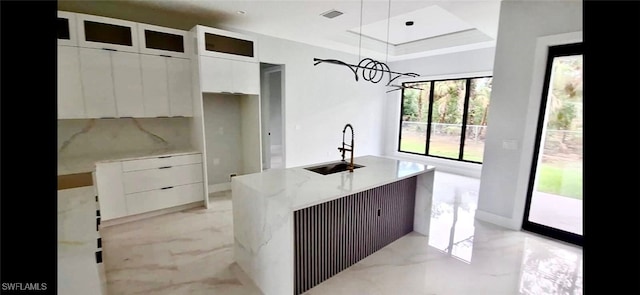 157 Everglades Blvd S, Naples, FL 34117 - kitchen featuring modern cabinets, white cabinetry, light marble finish flooring, a center island with sink, and hanging light fixtures