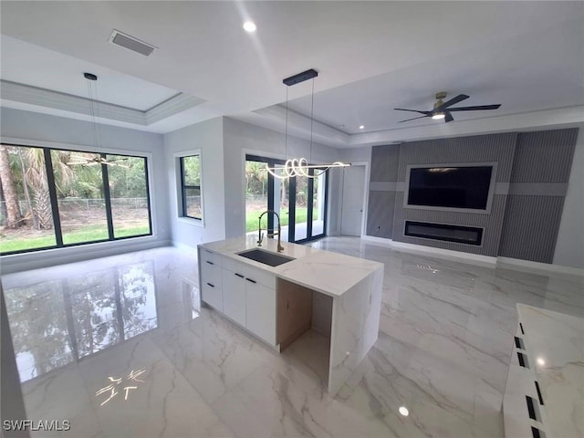 157 Everglades Blvd S, Naples, FL 34117 - kitchen featuring a raised ceiling, modern cabinets, white cabinets, a chandelier, and recessed lighting