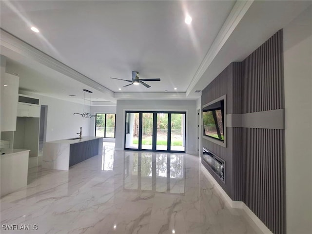 157 Everglades Blvd S, Naples, FL 34117 - unfurnished living room with a raised ceiling, light marble finish floors, a ceiling fan, a large fireplace, and recessed lighting
