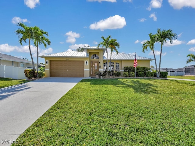3904 SW 20th Ave, Cape Coral, FL 33914 - view of front of house featuring concrete driveway, stucco siding, fence, an attached garage, and a front yard