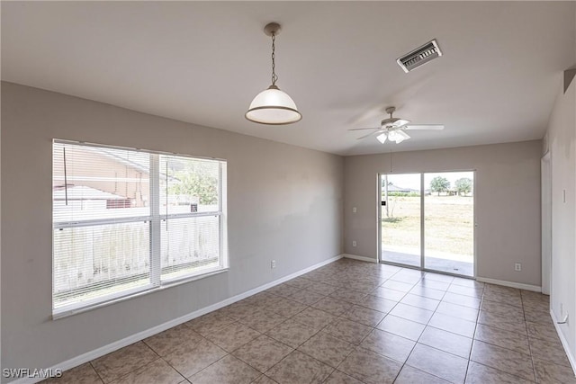 spare room with baseboards, visible vents, light tile patterned floors, and a ceiling fan