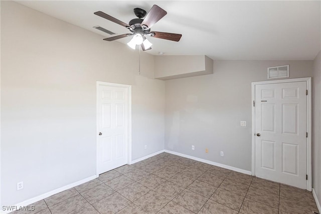 unfurnished room featuring baseboards, visible vents, ceiling fan, and vaulted ceiling