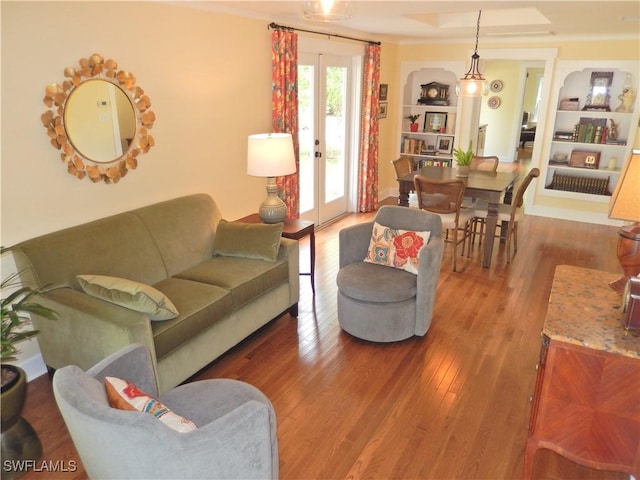 living room featuring ornamental molding, french doors, and wood finished floors
