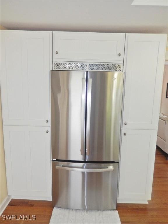 215 Granada Blvd, Fort Myers, FL 33905 - kitchen with freestanding refrigerator, white cabinets, and wood finished floors