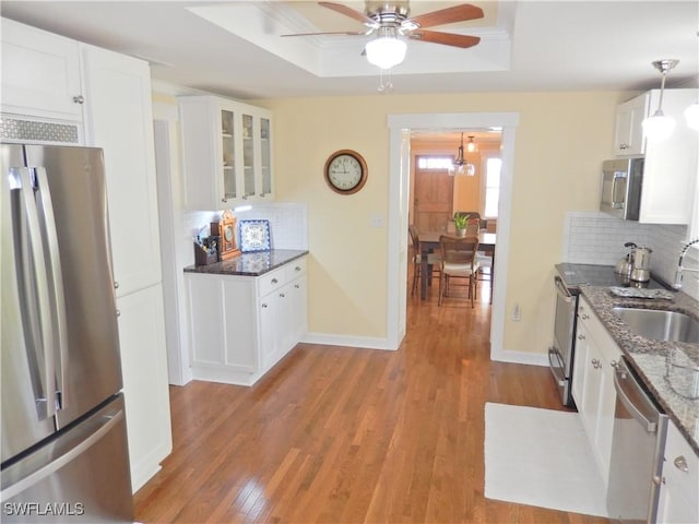 215 Granada Blvd, Fort Myers, FL 33905 - kitchen featuring appliances with stainless steel finishes, a ceiling fan, tasteful backsplash, and wood finished floors