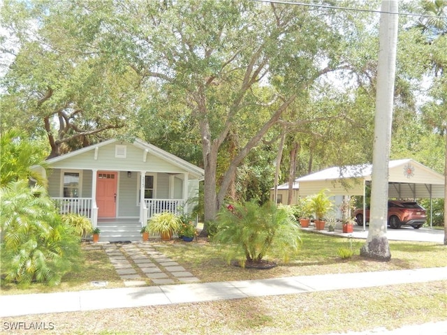 bungalow-style house featuring a carport and a porch