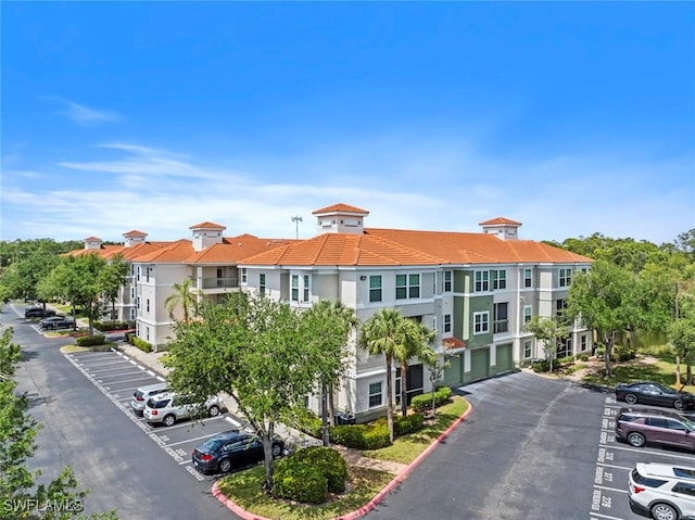 23560 Walden Center Dr Unit 306, Estero, FL 34134 - view of building exterior with uncovered parking