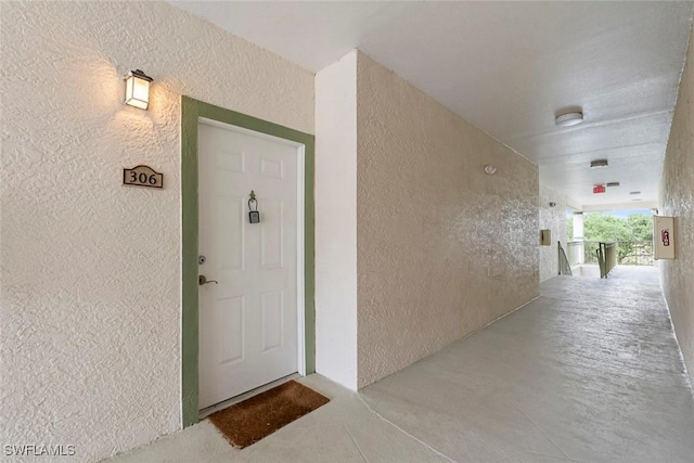 doorway to property featuring stucco siding
