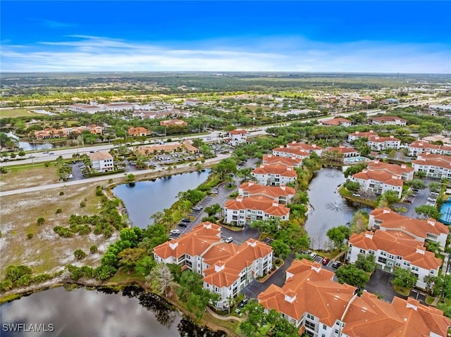 drone / aerial view featuring a residential view and a water view