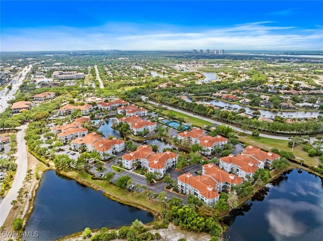 drone / aerial view featuring a residential view and a water view