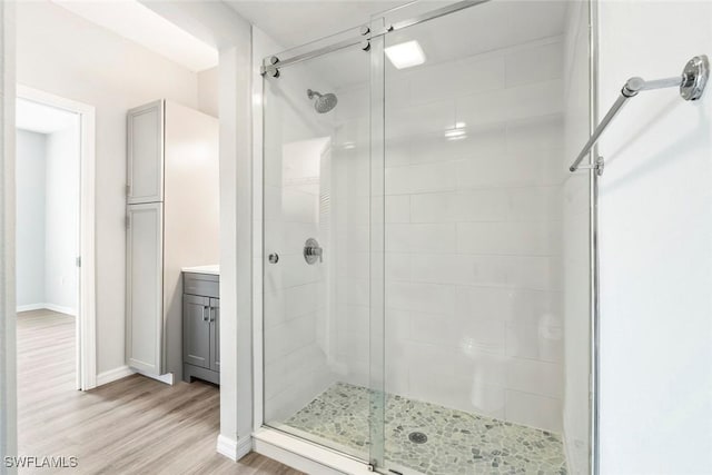 23560 Walden Center Dr Unit 306, Estero, FL 34134 - full bath featuring a shower stall, wood finished floors, baseboards, and vanity