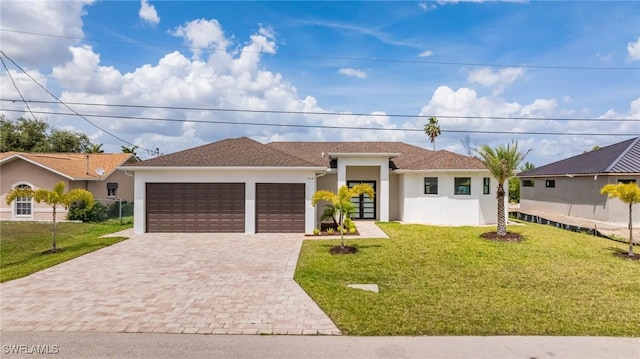 309 SW 15th Ter, Cape Coral, FL 33991 - view of front facade featuring stucco siding, driveway, a garage, and a front yard
