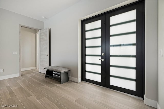 309 SW 15th Ter, Cape Coral, FL 33991 - entrance foyer with baseboards, french doors, and wood finish floors