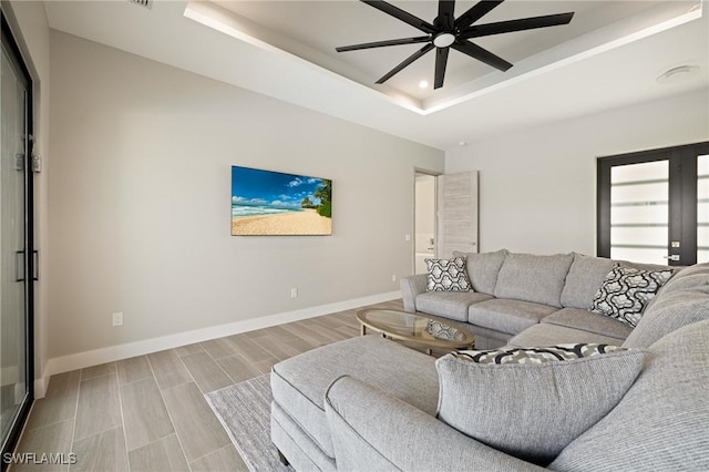 309 SW 15th Ter, Cape Coral, FL 33991 - living room with a raised ceiling, baseboards, wood tiled floor, ceiling fan, and recessed lighting