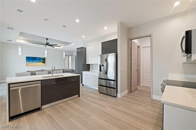 309 SW 15th Ter, Cape Coral, FL 33991 - kitchen with light countertops, modern cabinets, appliances with stainless steel finishes, a sink, and open floor plan