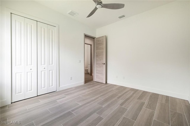309 SW 15th Ter, Cape Coral, FL 33991 - unfurnished bedroom featuring a closet, visible vents, baseboards, ceiling fan, and wood finish floors
